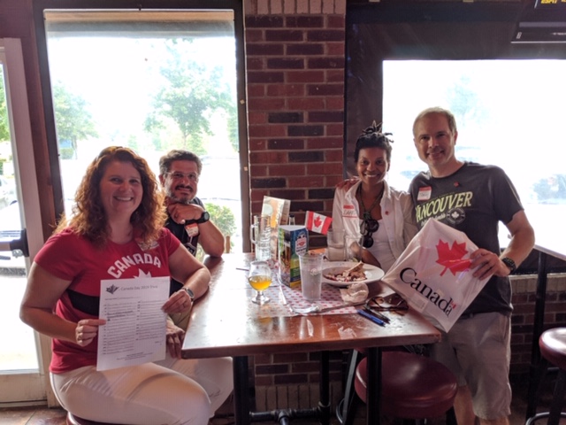 Four people team receiving prize for trivia game